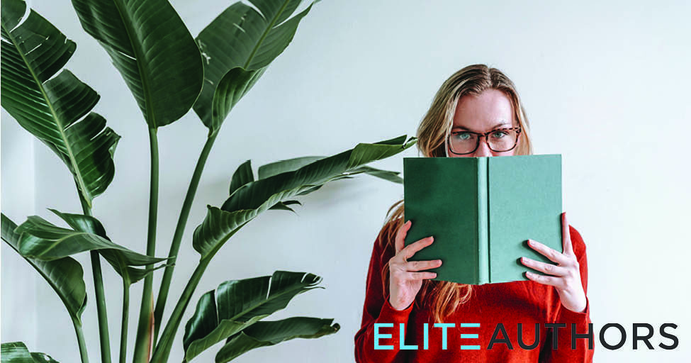 person holding book to their face by big plant