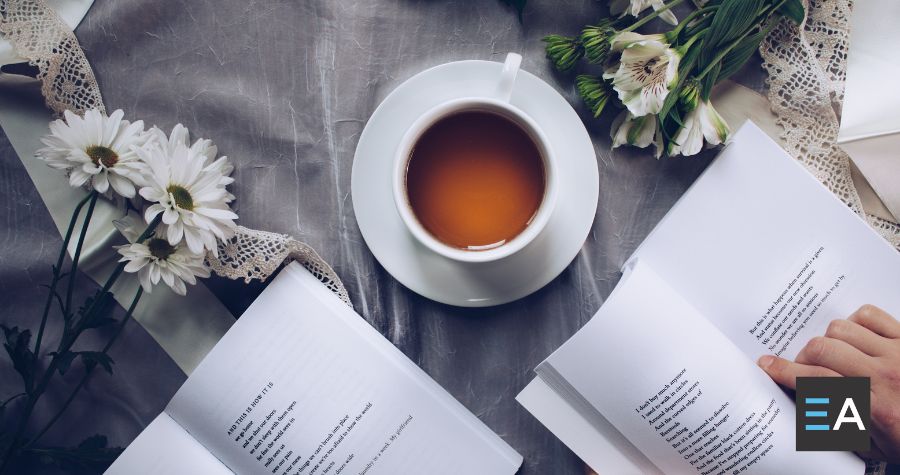 Open poetry books near a cup of tea