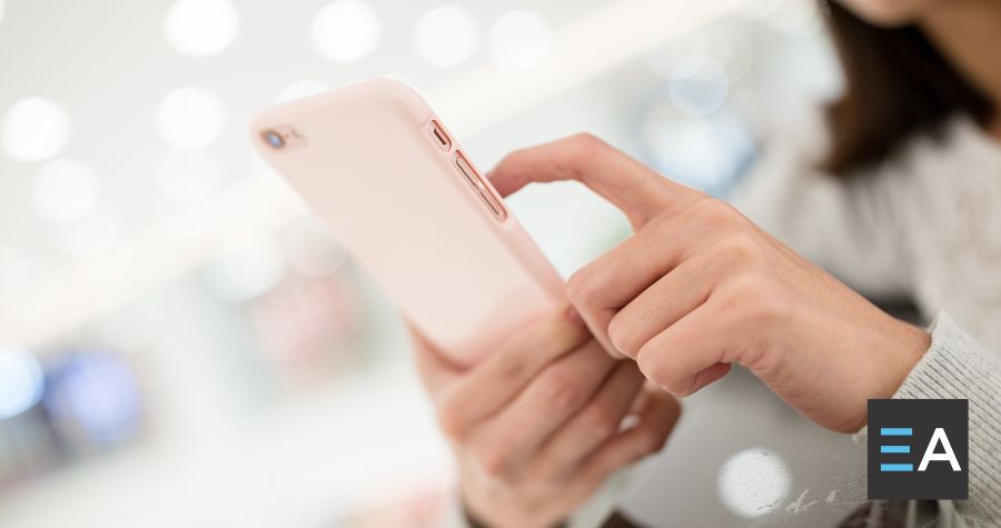 A person interacting with a pink smartphone