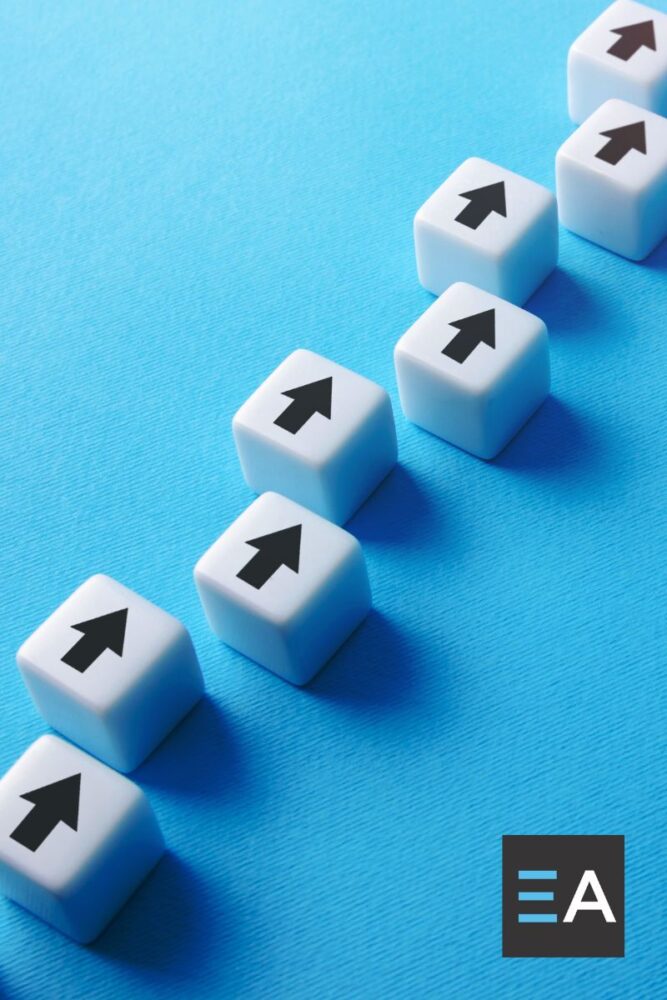White cubes with black arrows on them lined up on a blue background