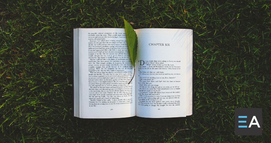 An open book with a green leaf between the pages
