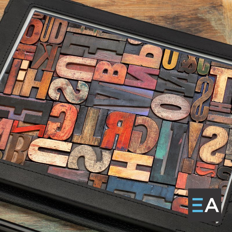 A box of multicolored typography letter tiles