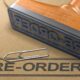A rubber stamp with the word "pre-order" on it