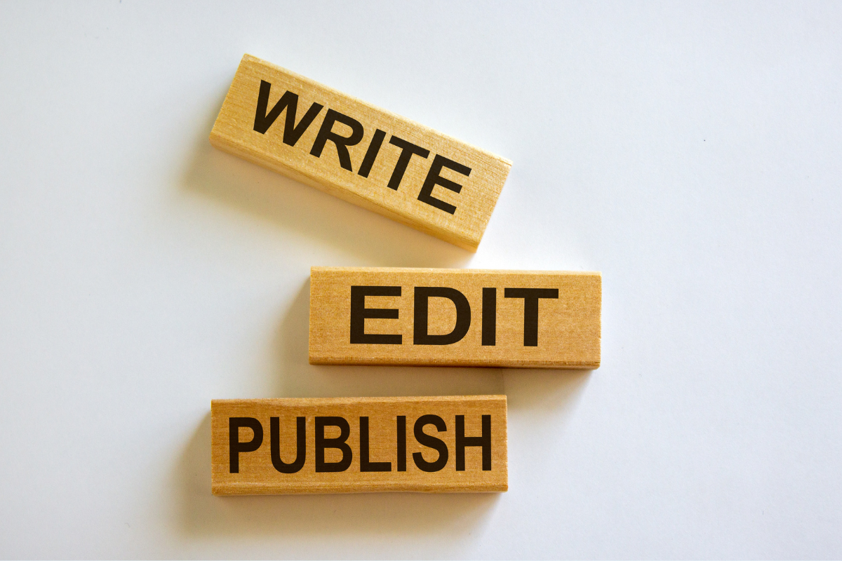 Wooden blocks with the words write, edit, and publish on them