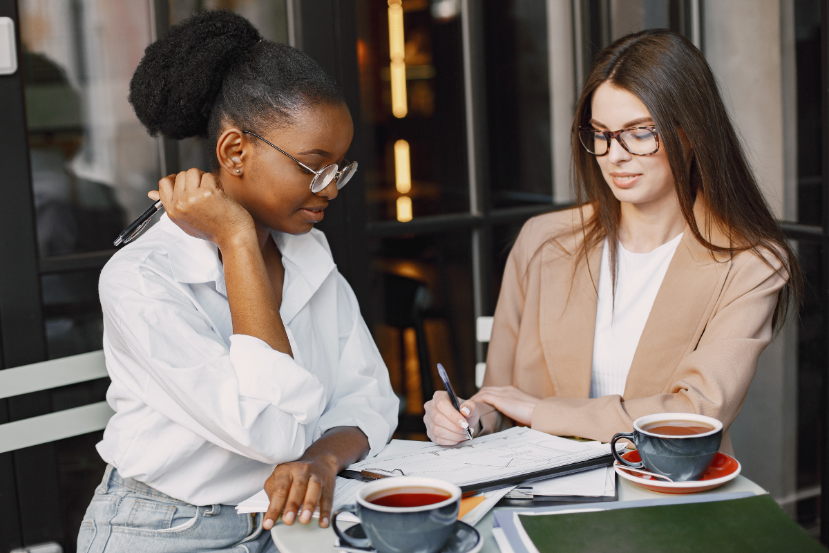 Author and publishing consultant reviewing page proofs and notes together