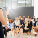 An author presents in front of an audience