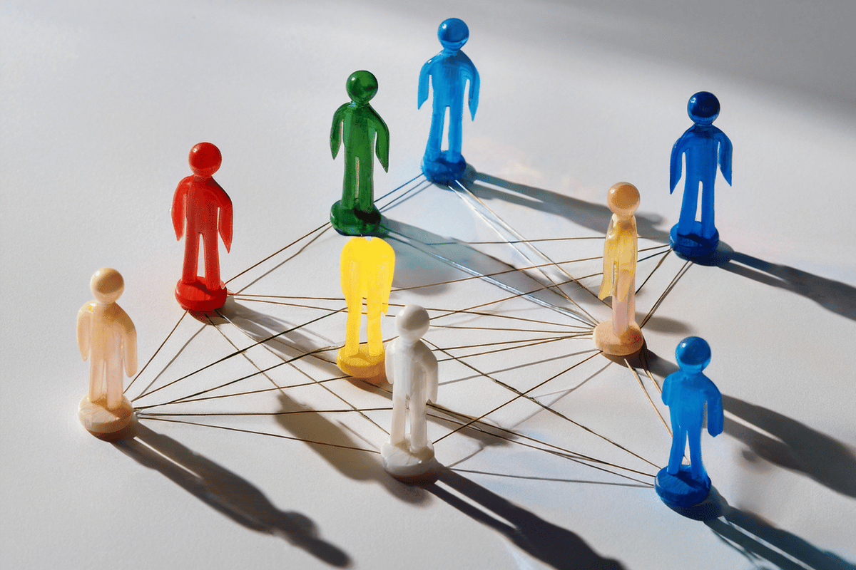 Plastic human figures connected by string