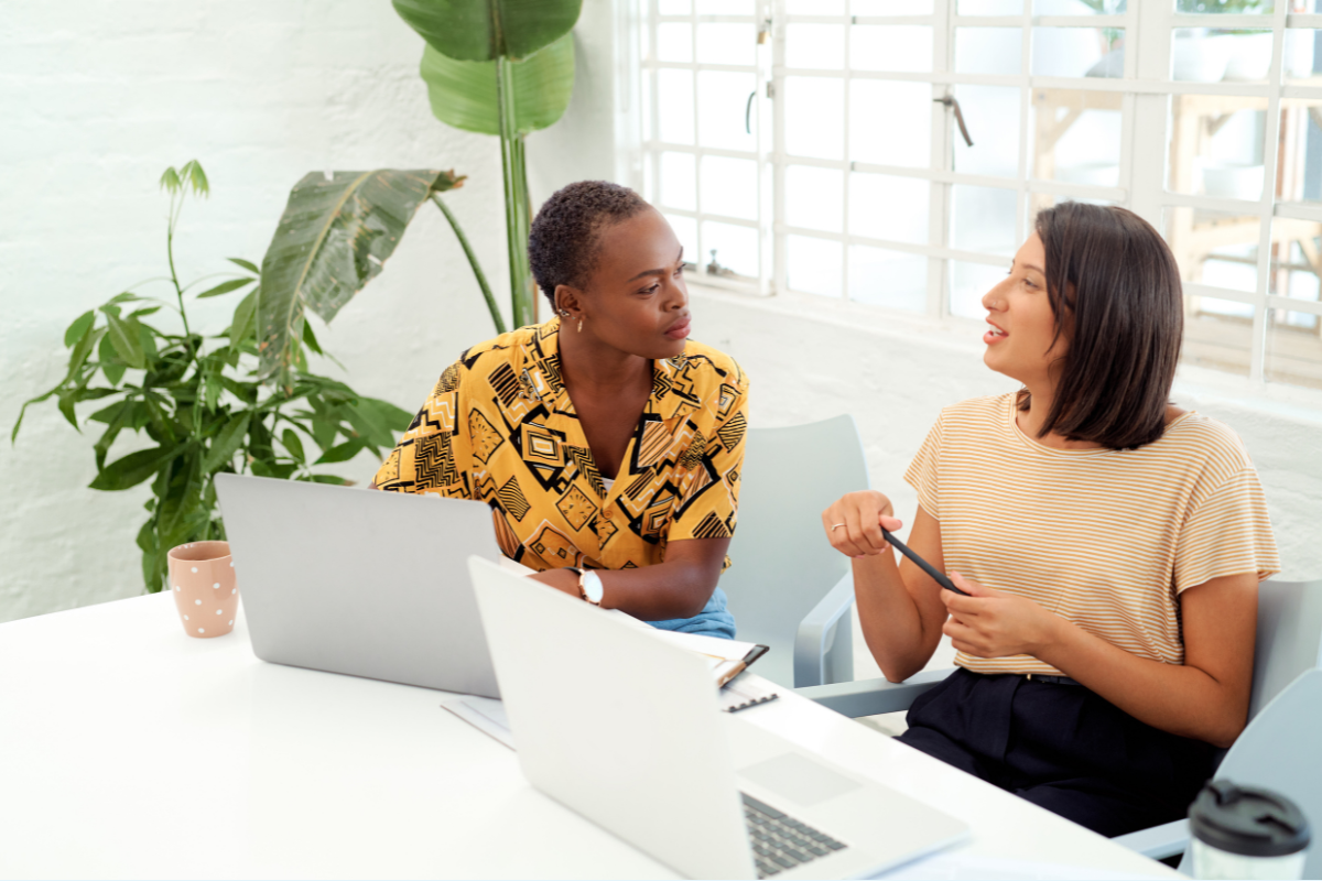 A writer consults with a professional at a desk
