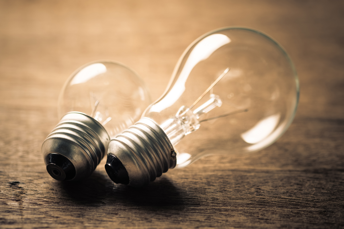 A large light bulb next to a smaller light bulb