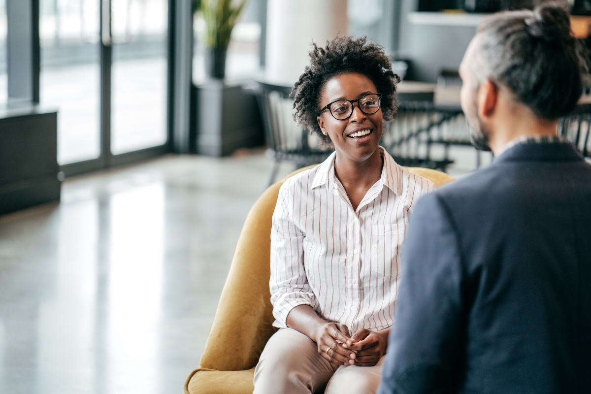 Two authors have discussion in an office setting