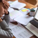 A business author looks frustrated at a cluttered desk