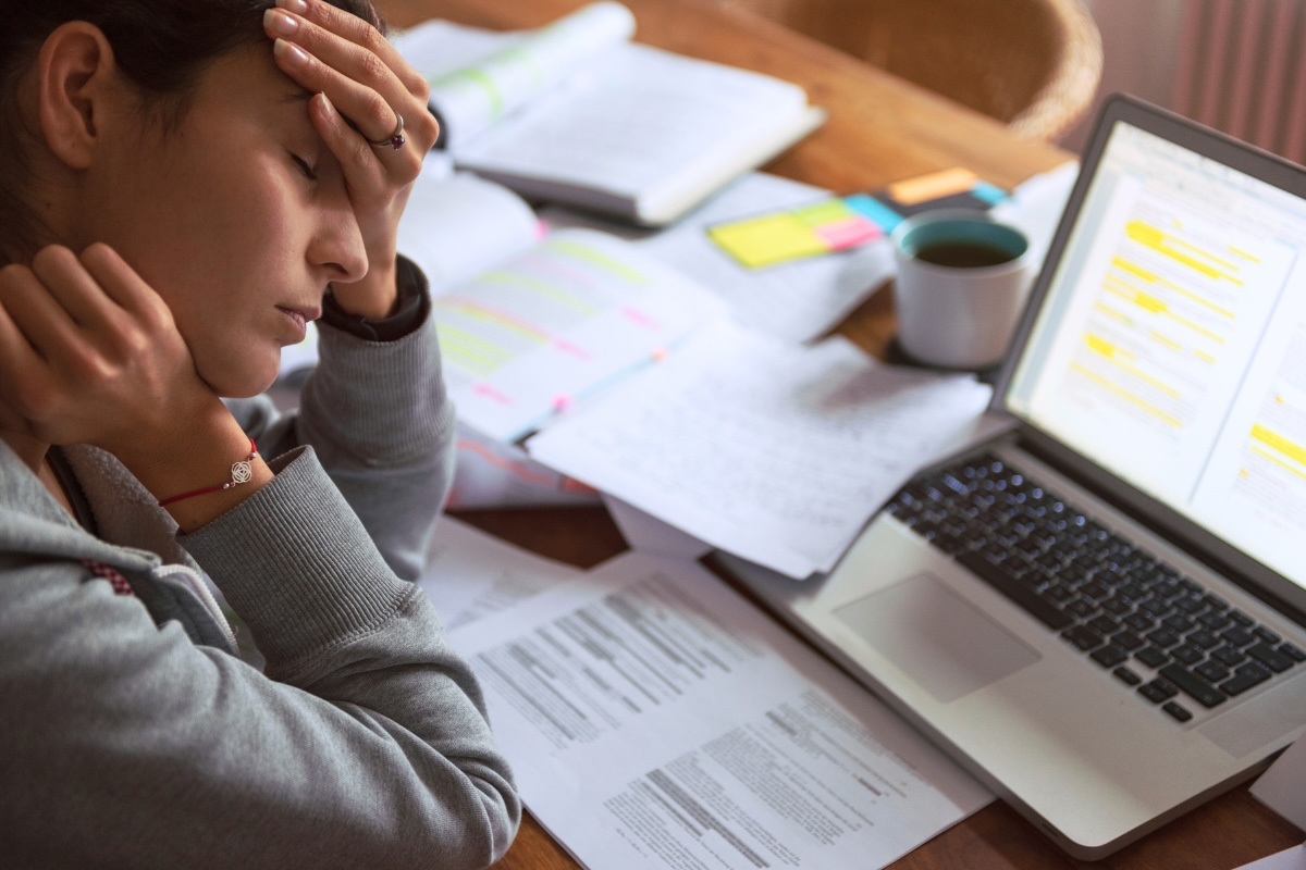 A business author looks frustrated at a cluttered desk