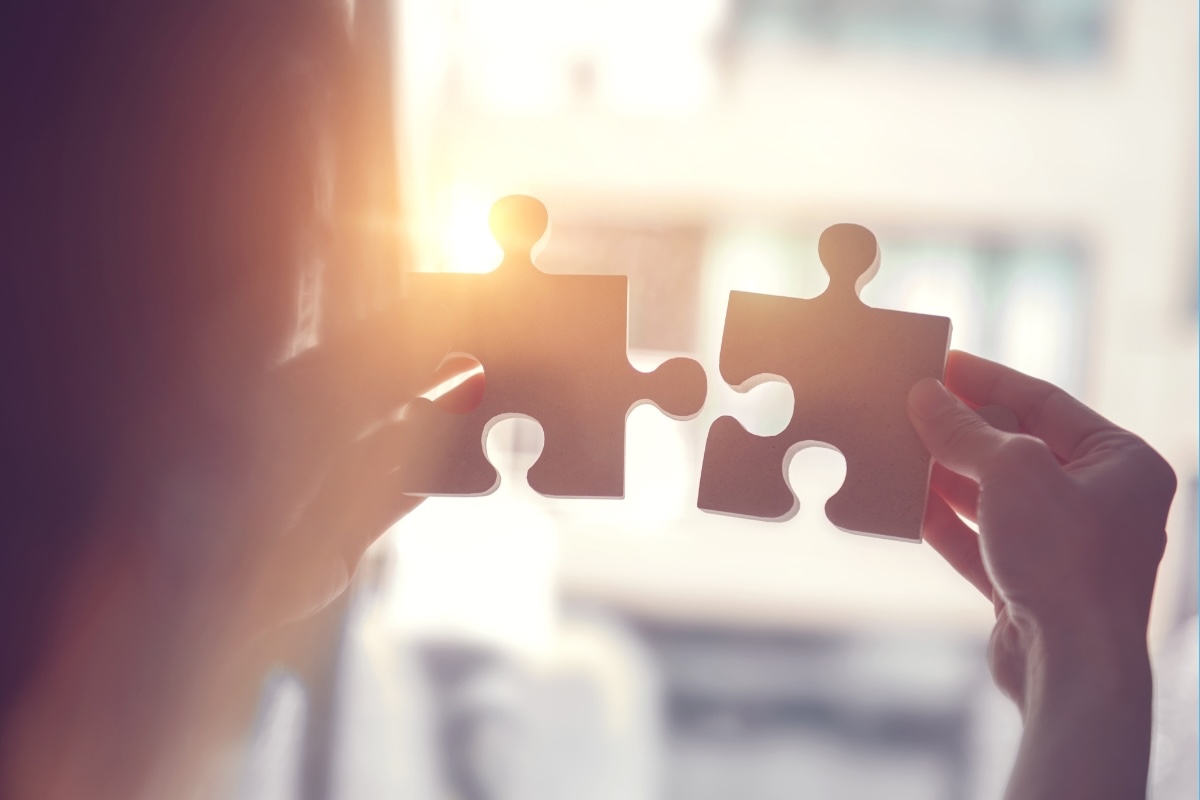 A person puts two large puzzle pieces together