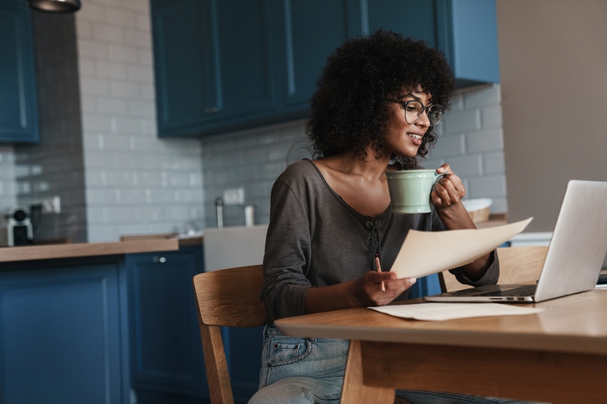 A business author working at a laptop in a kitchen