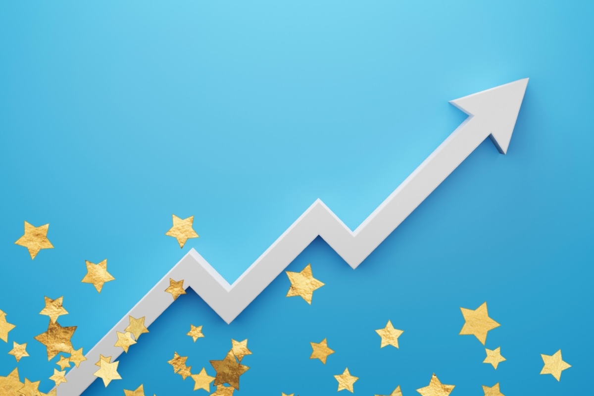 An upward pointing graph rises from a field of stars