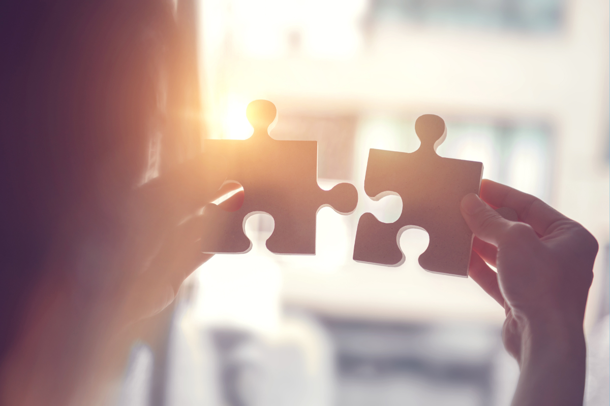 A person connects two large puzzle pieces