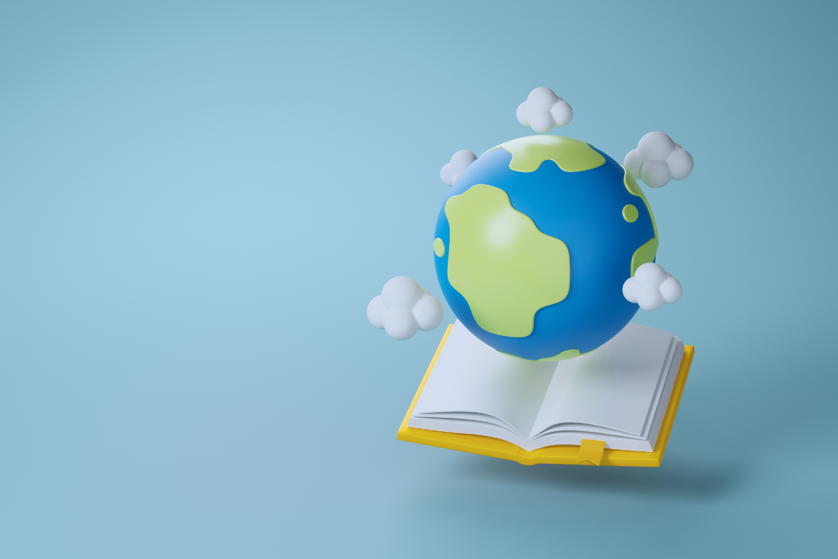 A globe hovering over an open book against a blue background