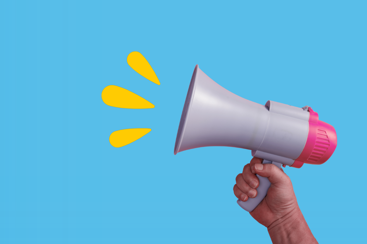 A person holds a megaphone emitting sound waves
