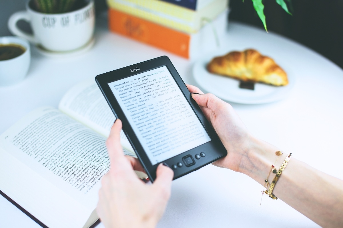 A person at a cafe enjoys an ebook