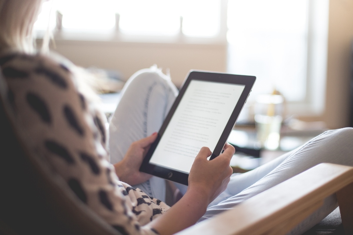 A person reads a digitally published book on an ereader
