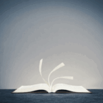 A self-published book lies open on a flat surface, its pages turning in the wind