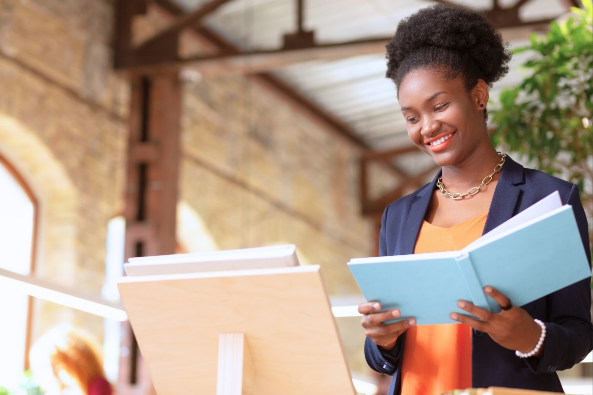 A business author holds a self-published book