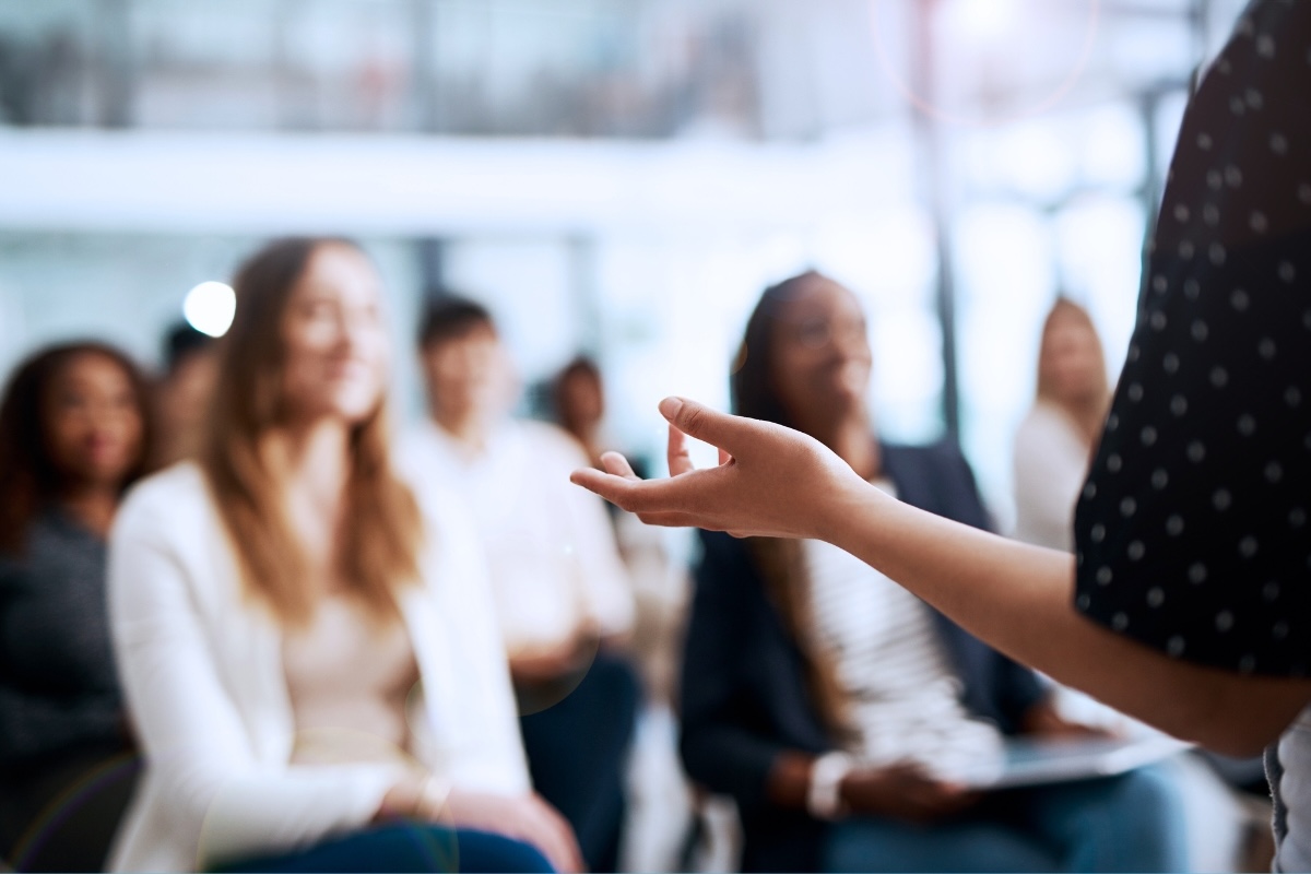 A person presents to a crowd.