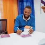 An author signs a copy of their book