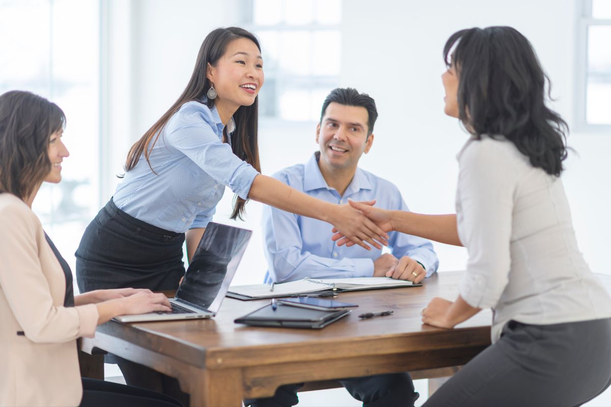Book marketing partners shake hands across a table