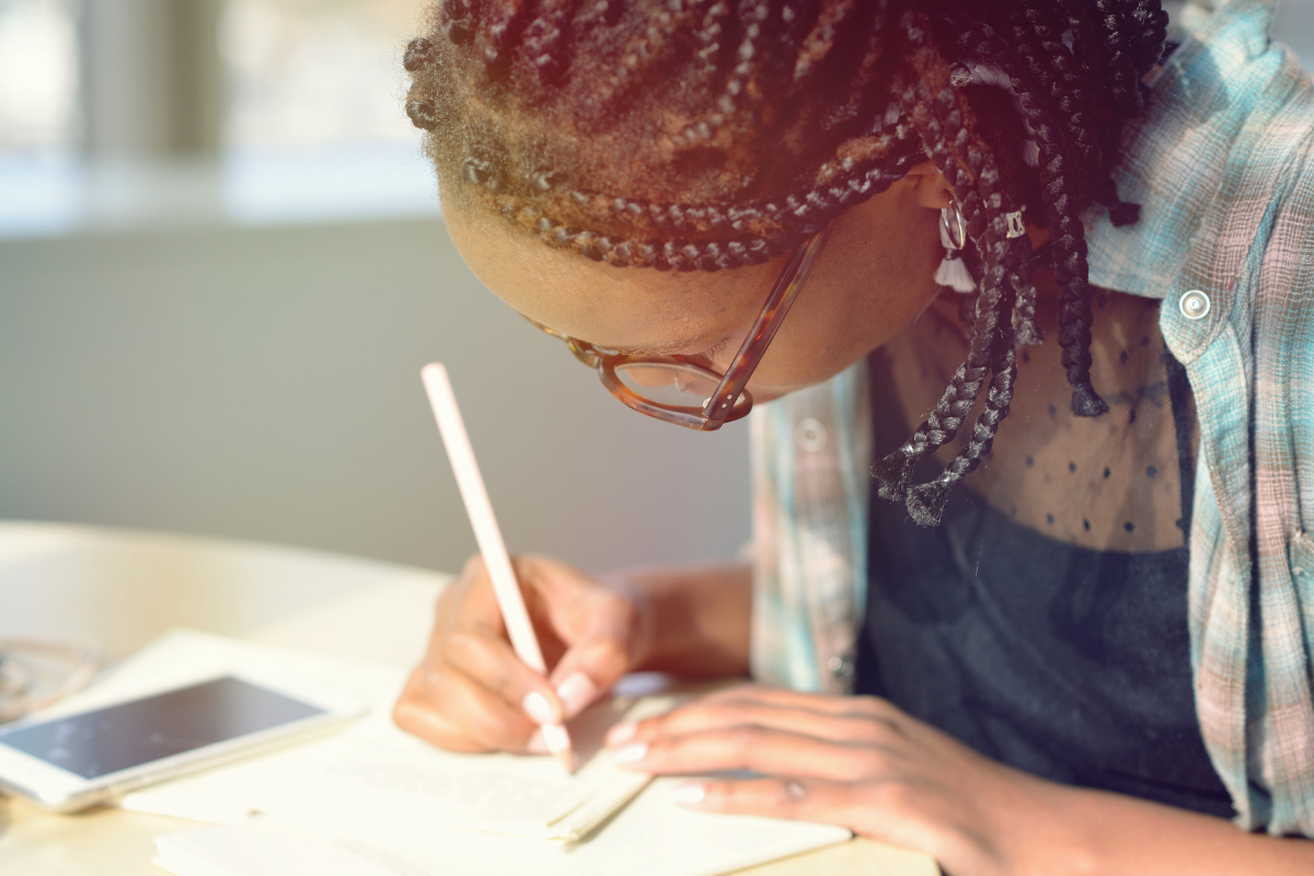 A person takes meticulous notes