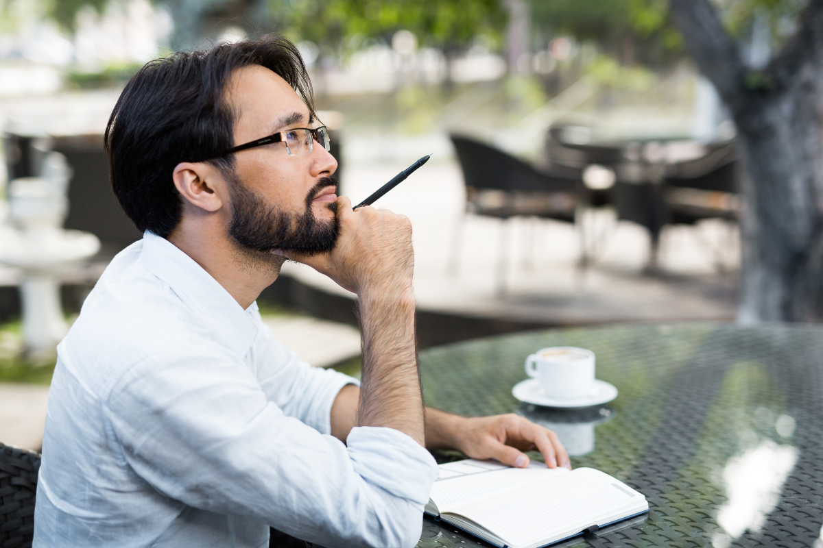 A person takes notes outside