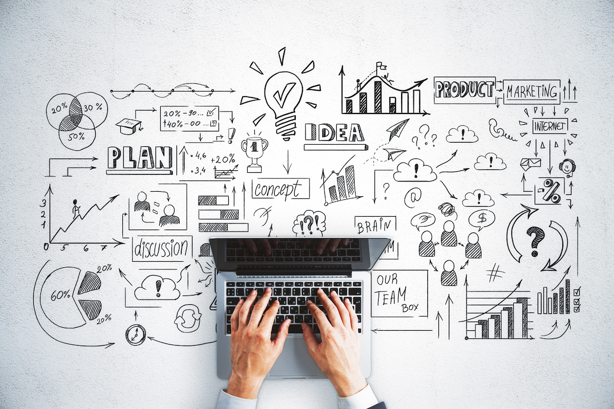 Top view of hands using laptop and drawing of global business interface on office desk