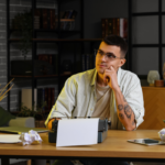 Author planning print, ebook, and audiobook formats at a desk