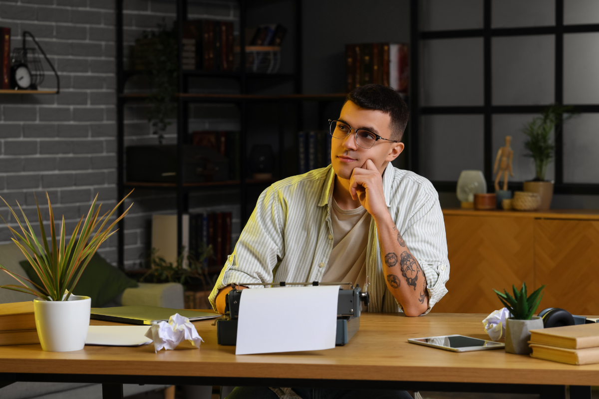 Author planning print, ebook, and audiobook formats at a desk