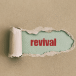 Brown paper torn to reveal the word "revival"