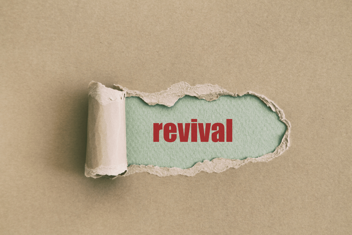 Brown paper torn to reveal the word "revival"
