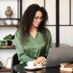 Independent author reading reader feedback about a book on a laptop