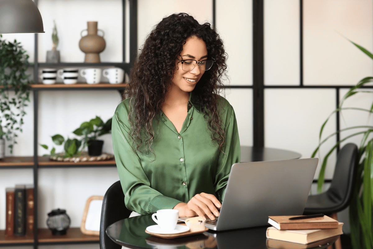 Independent author reading reader feedback about a book on a laptop