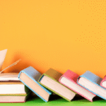 A stack of books in a line tipped over like dominoes