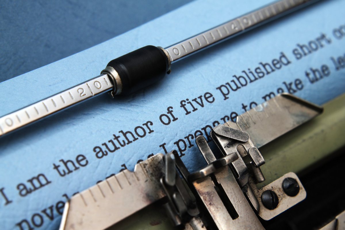 A typewriter showing an author bio