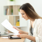 Author comparing two marked-up manuscript pages or versions of a document