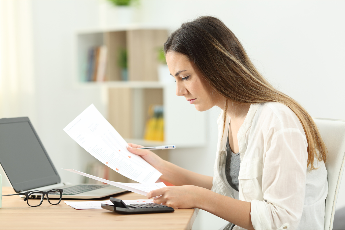 Author comparing two marked-up manuscript pages or versions of a document