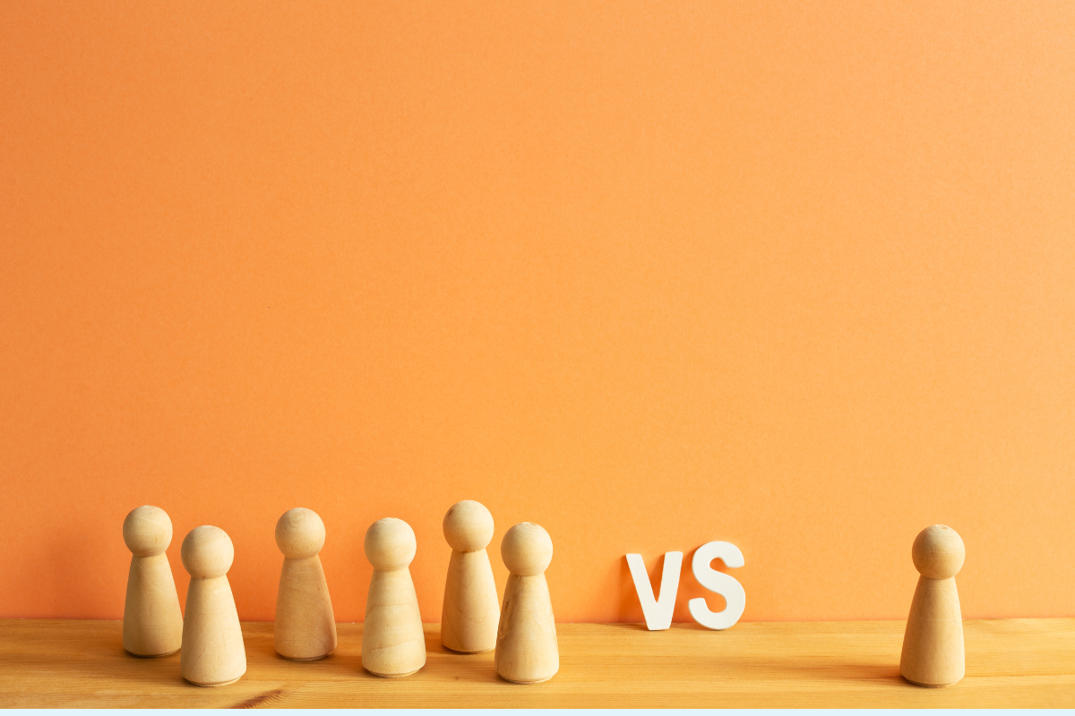 Wooden pawns in a group on the left versus one single pawn on the right