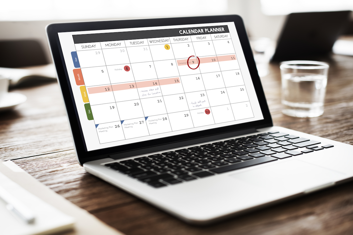 A laptop displaying an annotated calendar