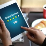 A person submits an online review on a tablet