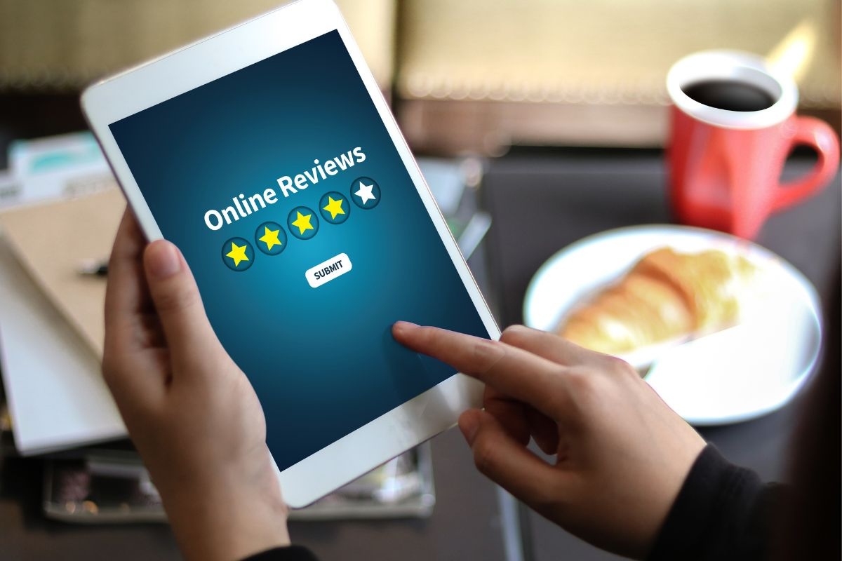 A person submits an online review on a tablet