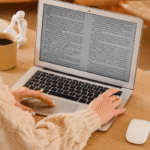 An author reviews an ARC on a laptop