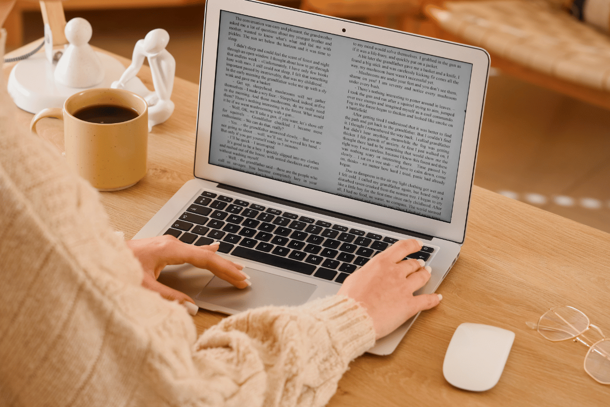 An author reviews an ARC on a laptop