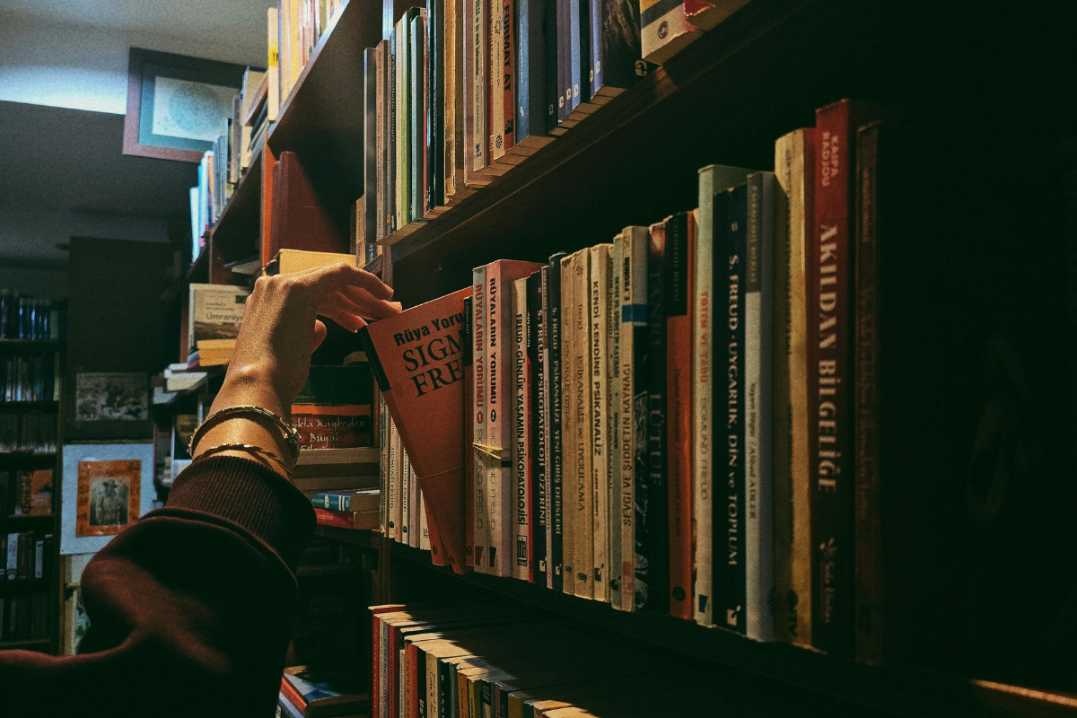 Reader revisiting saved books while choosing what to read next